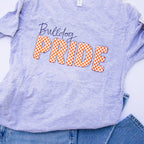 A light heather purple t-shirt with 'Bulldog PRIDE' printed on the front, styled flat-lay with blue jeans on a white background.