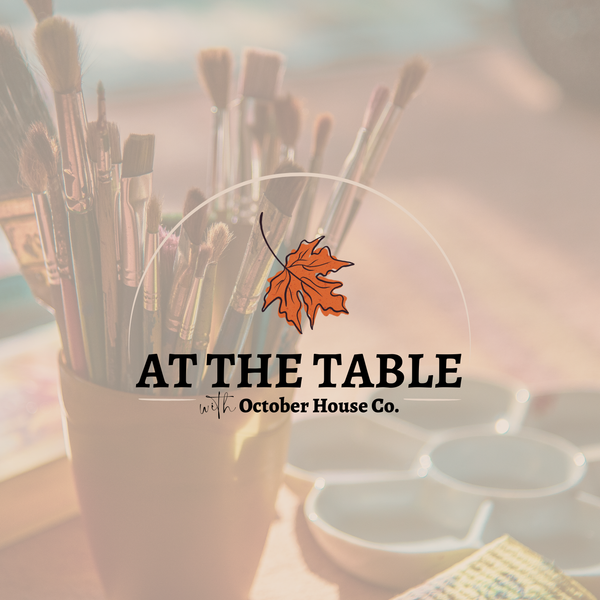 Paintbrushes in a cup with 'At the Table with October House Co.' text and logo for the monthly virtual LIVE experience hosted from Hartville, Ohio