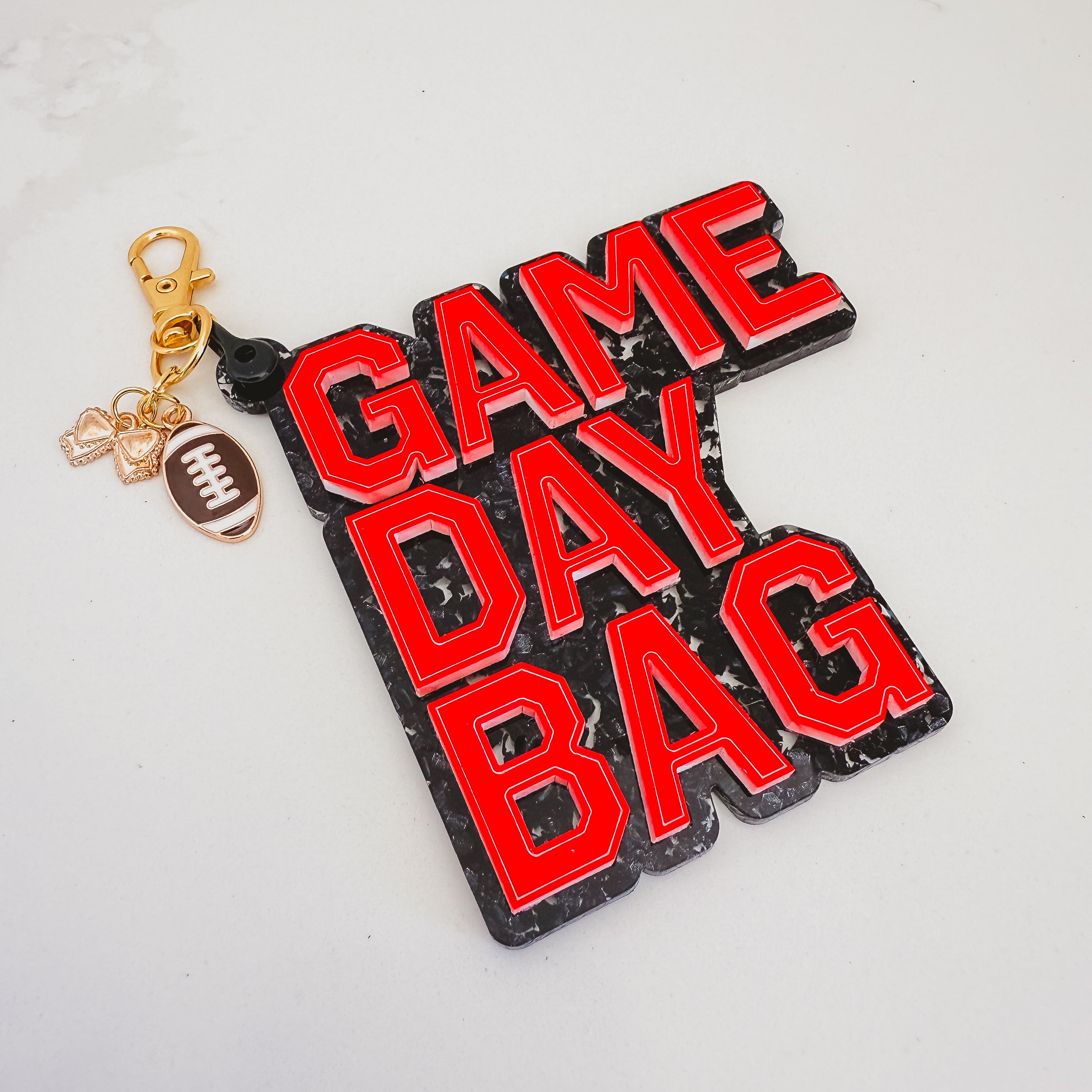 Keychain with 'GAME DAY BAG' text on a light gray background by October House Co. in Hartville, Ohio.