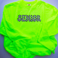 A neon green long-sleeve t-shirt with 'SENIOR' printed across the chest in a black and white checkered font, laid flat on a gray background.