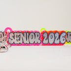 Colorful keychain with 'Senior 2026' text on a light gray background by October House Co. in Hartville, Ohio.