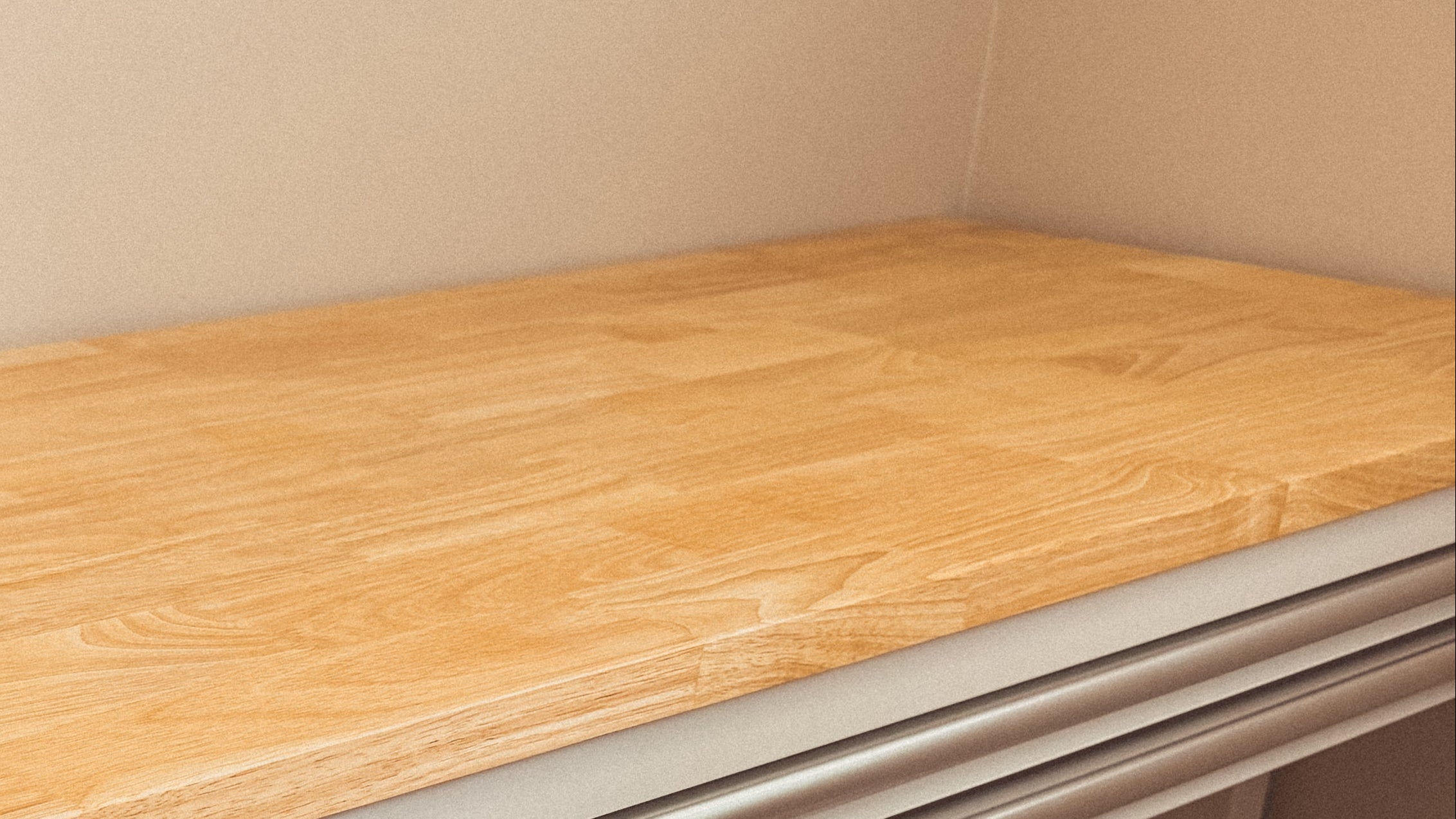 Wooden surface of a Husky workbench with a neutral background at October House Co. home studio in Hartville, Ohio.